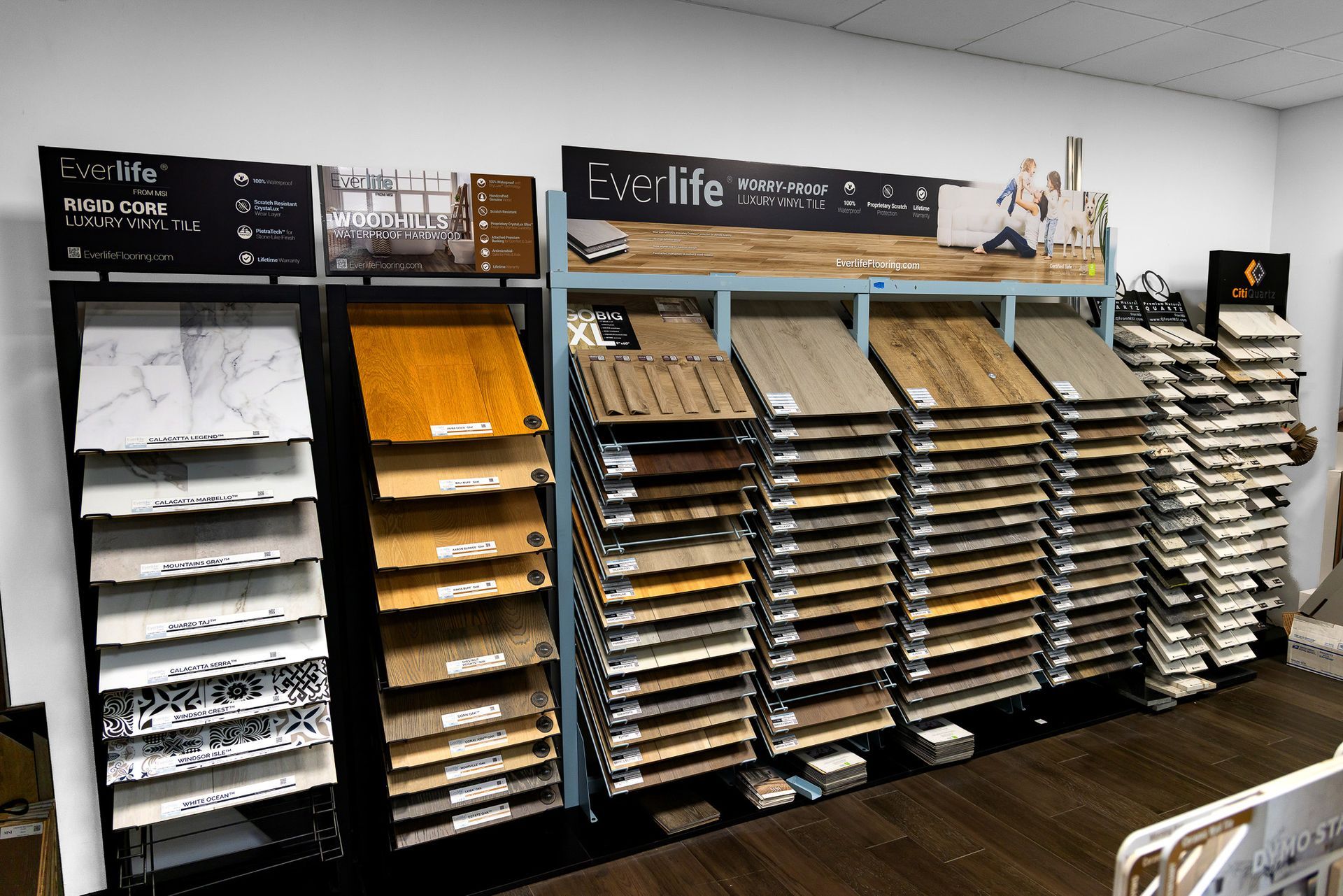 Display of shelves with assorted paper samples and cards in a store or showroom