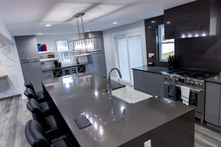 Modern kitchen with large island, stainless appliances, and open dining area