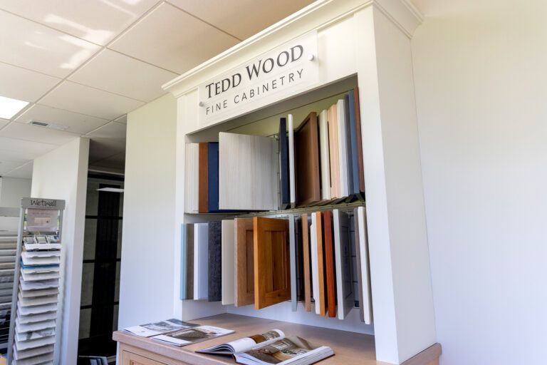 Interior showroom with fabric samples displayed on shelves under a “TEDD WOOD” sign
