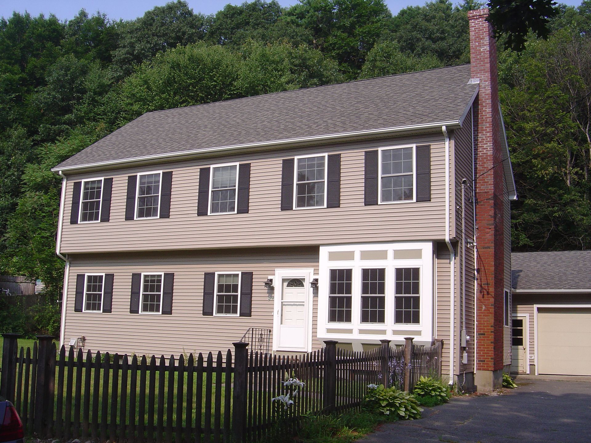 A house with a wooden fence in front of it