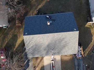 An aerial view of a house with a new roof.