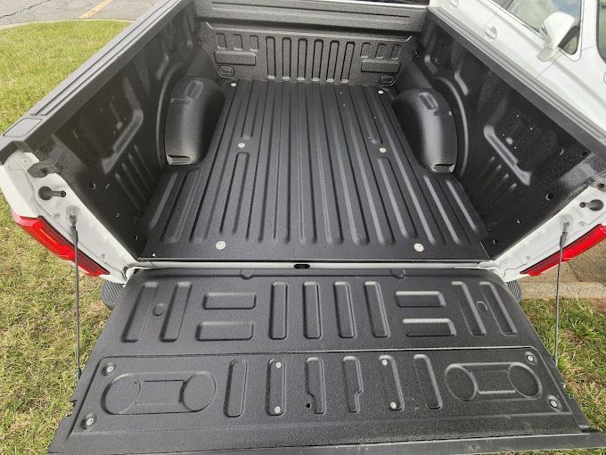 The back of a pickup truck with the tailgate open