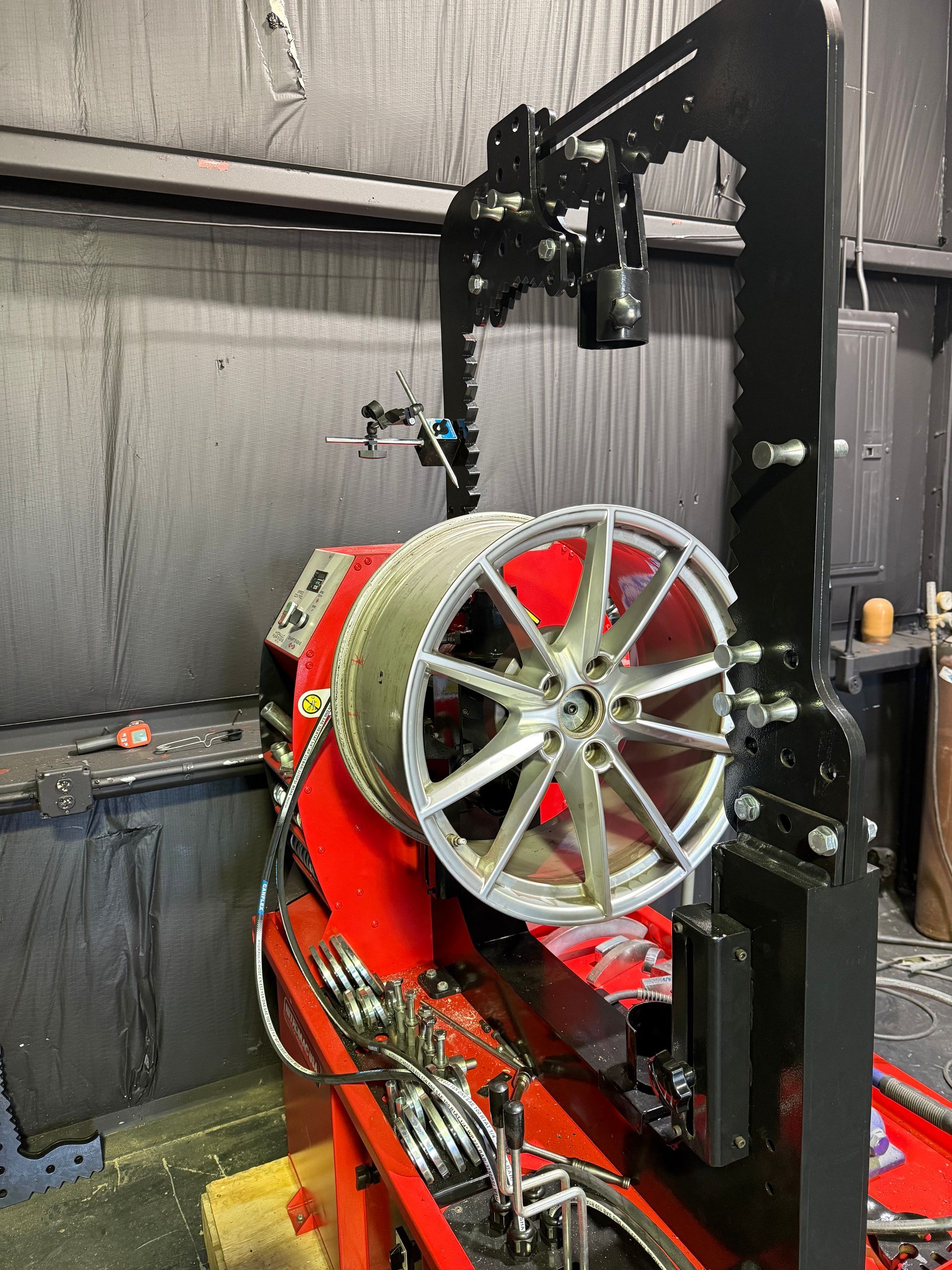 A wheel is being repaired on a machine in a garage.