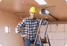 Worker after installing garage lifter