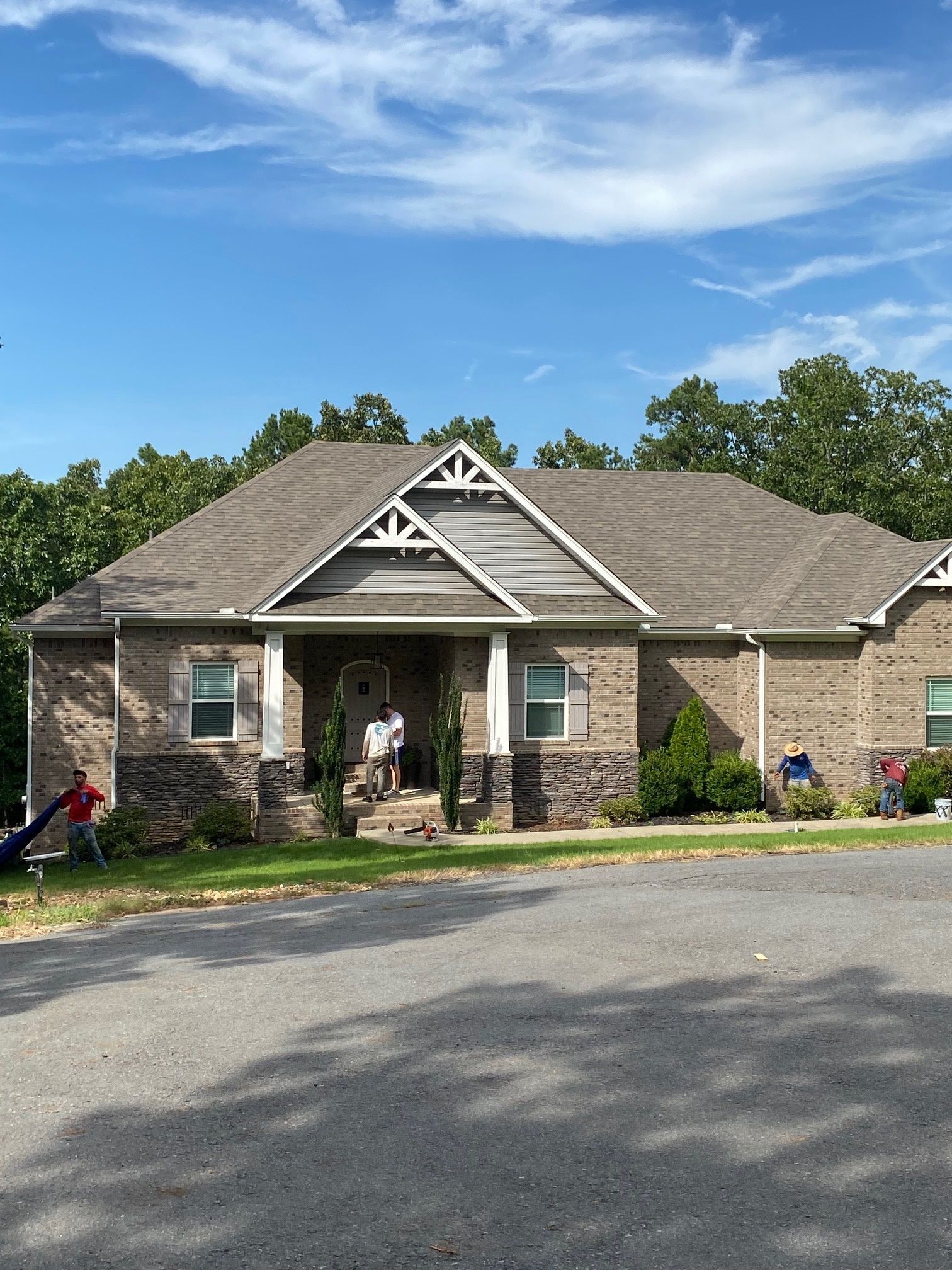 A brick house with a roof that has a triangle on it