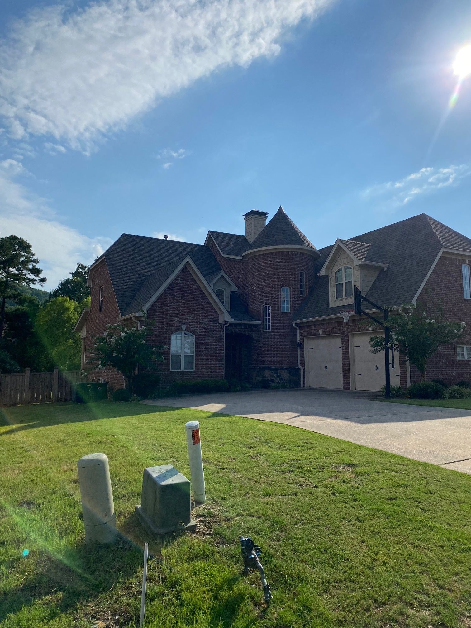 A large brick house with a lot of grass in front of it.