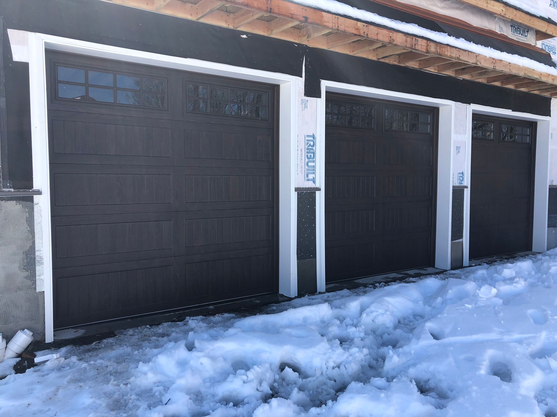 A row of garage doors sitting next to each other in the snow.