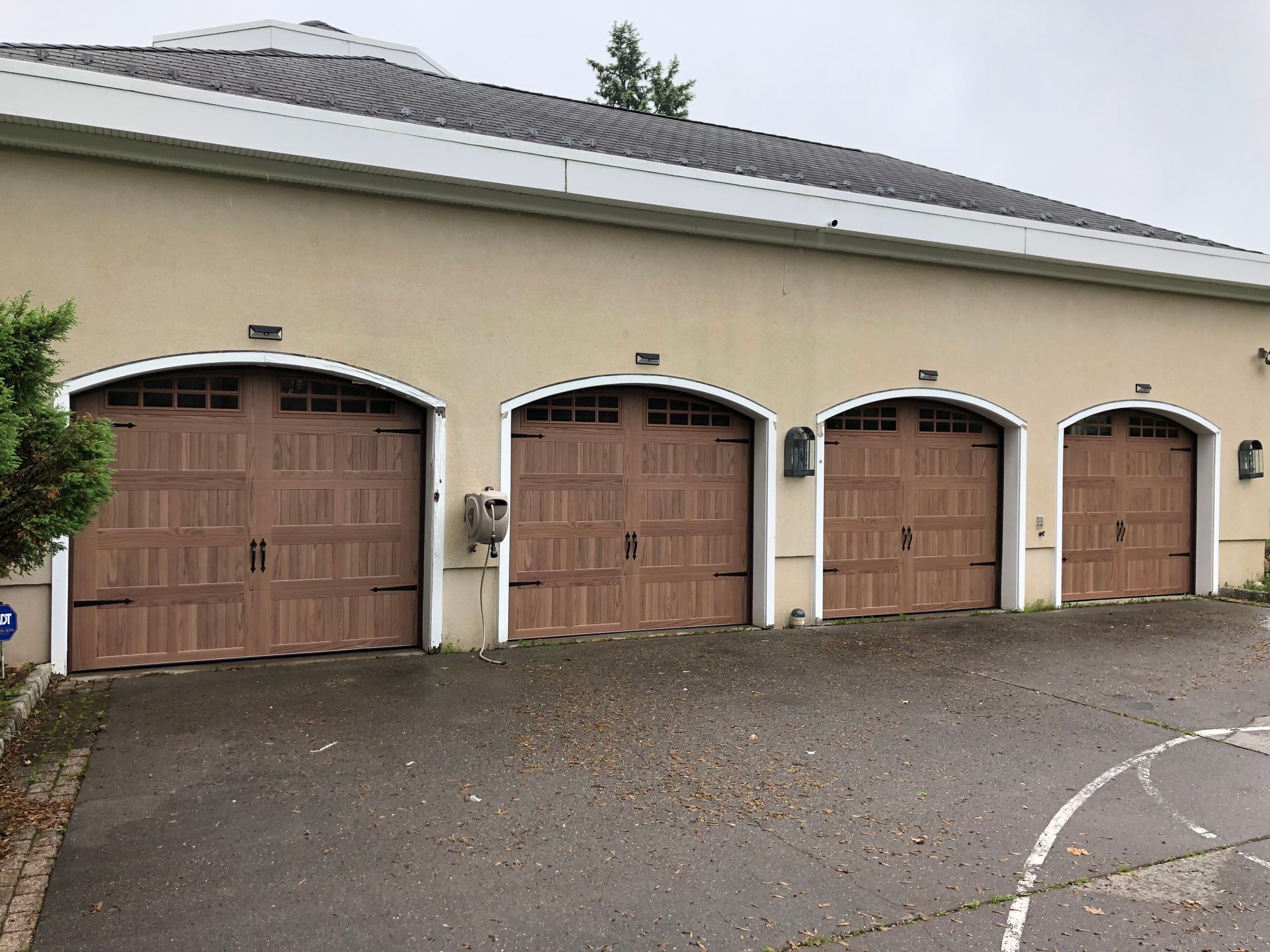 A row of garage doors are lined up on the side of a building.