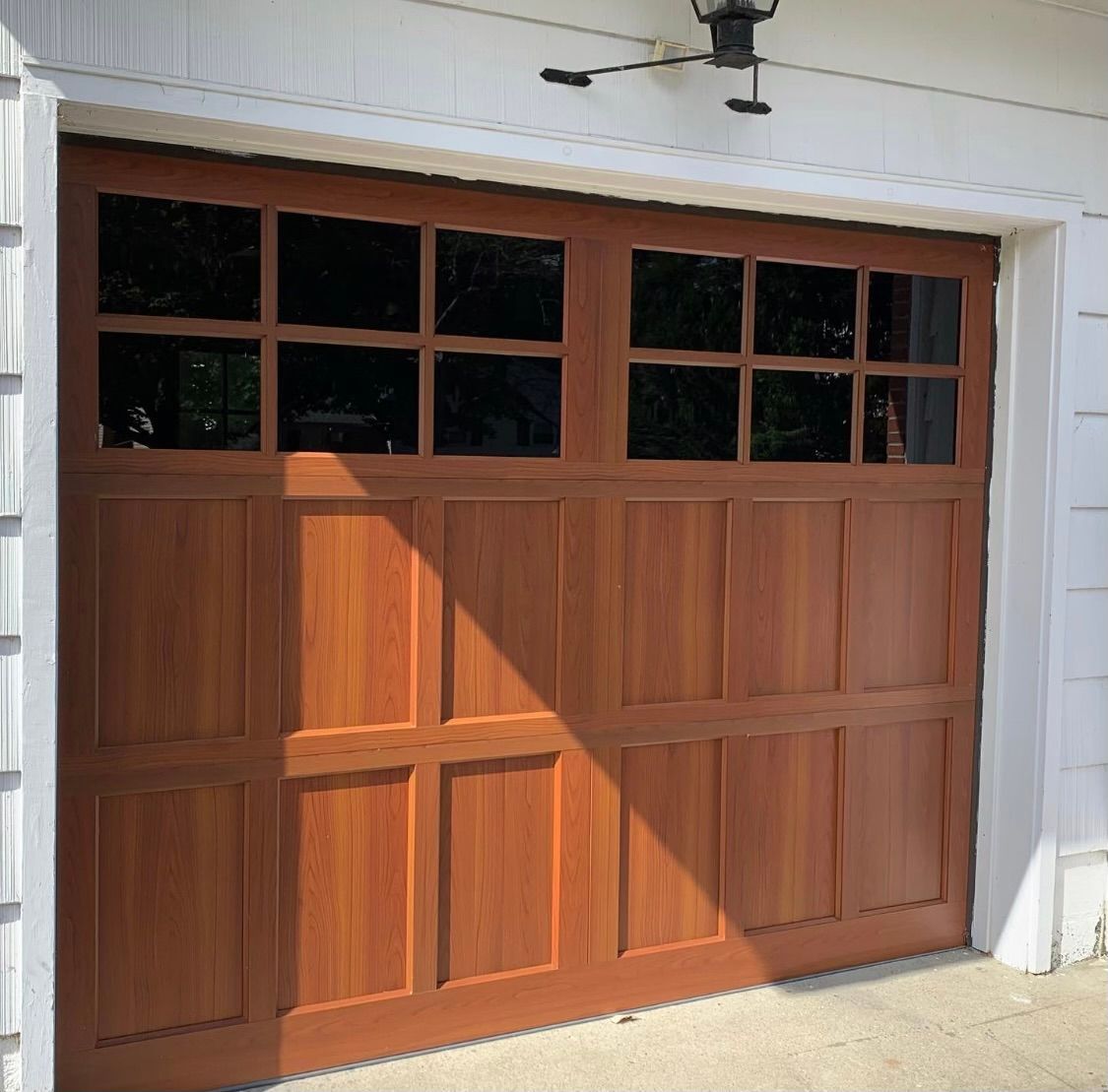 A wooden garage door with a lot of windows