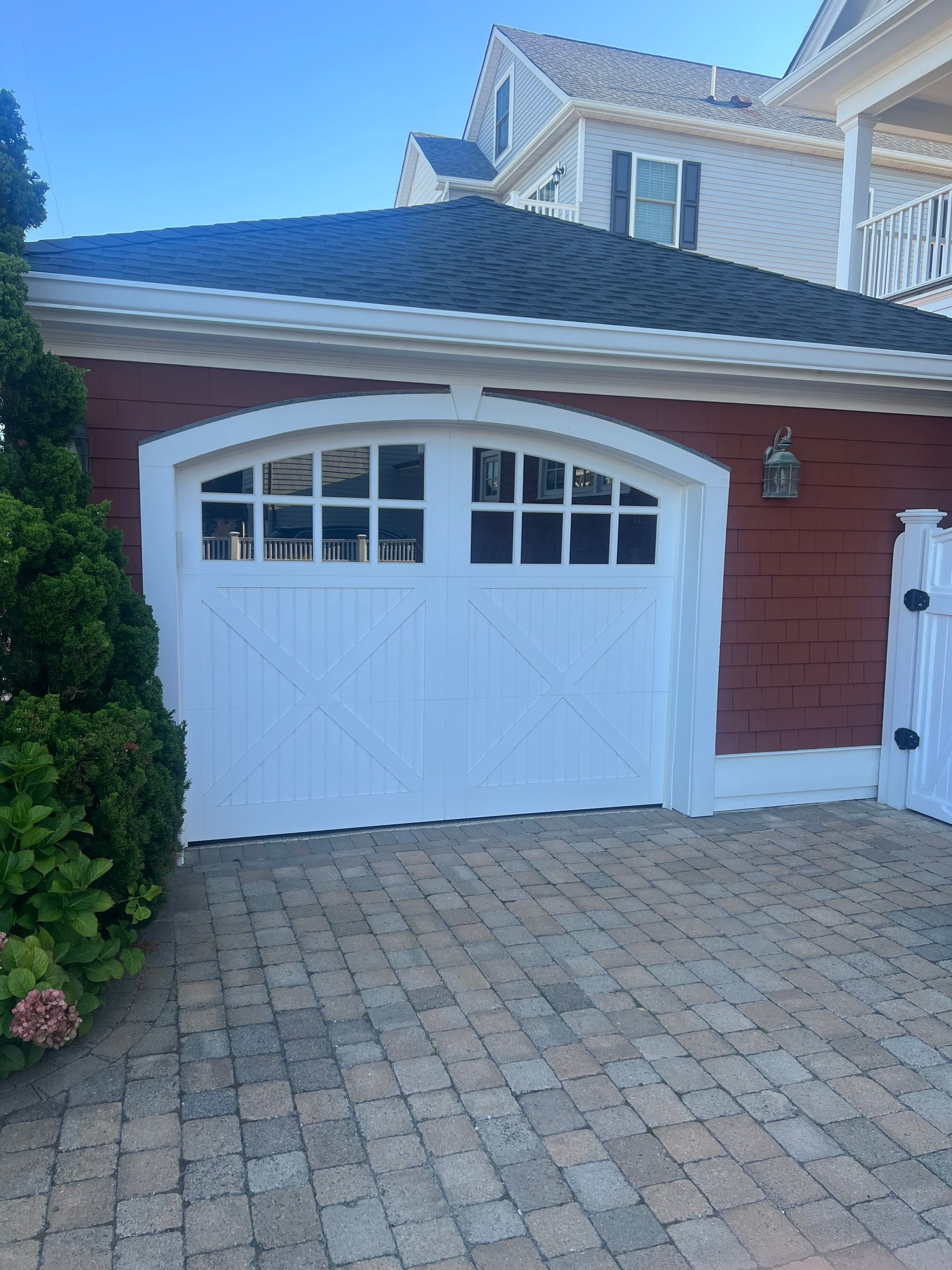 A red house with a white garage door