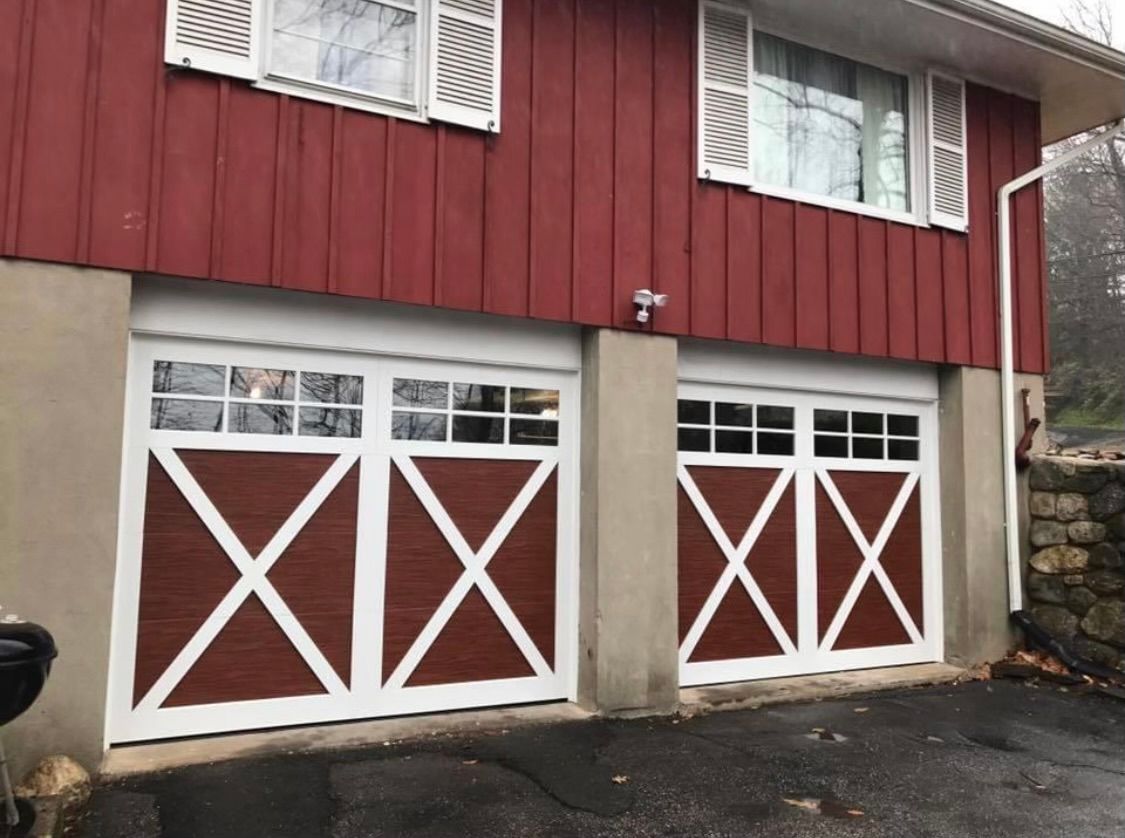 A red house with a white garage door
