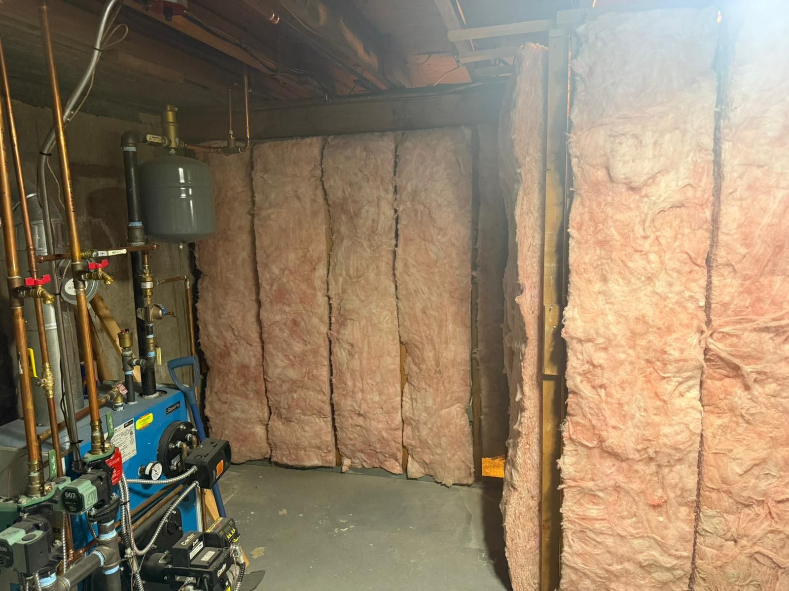 Basement wall with pink insulation panels