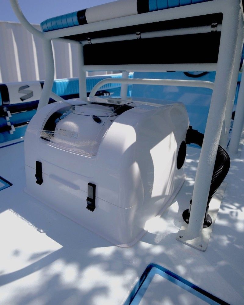 A blue and white boat with a white box underneath it