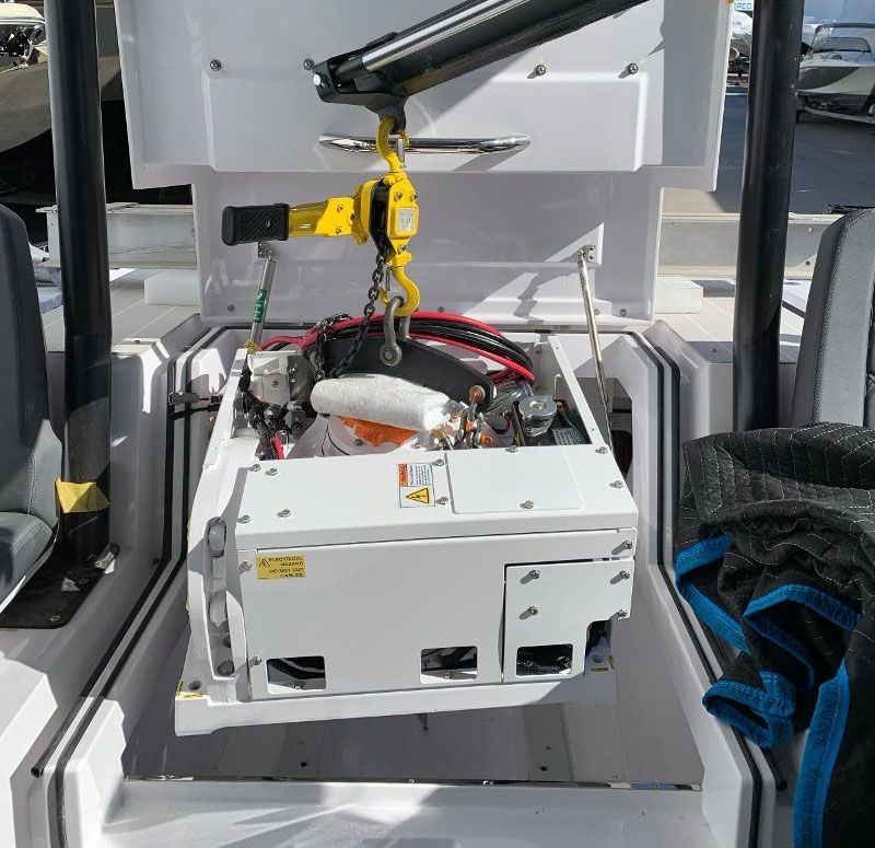 A white box with a yellow crane attached to it