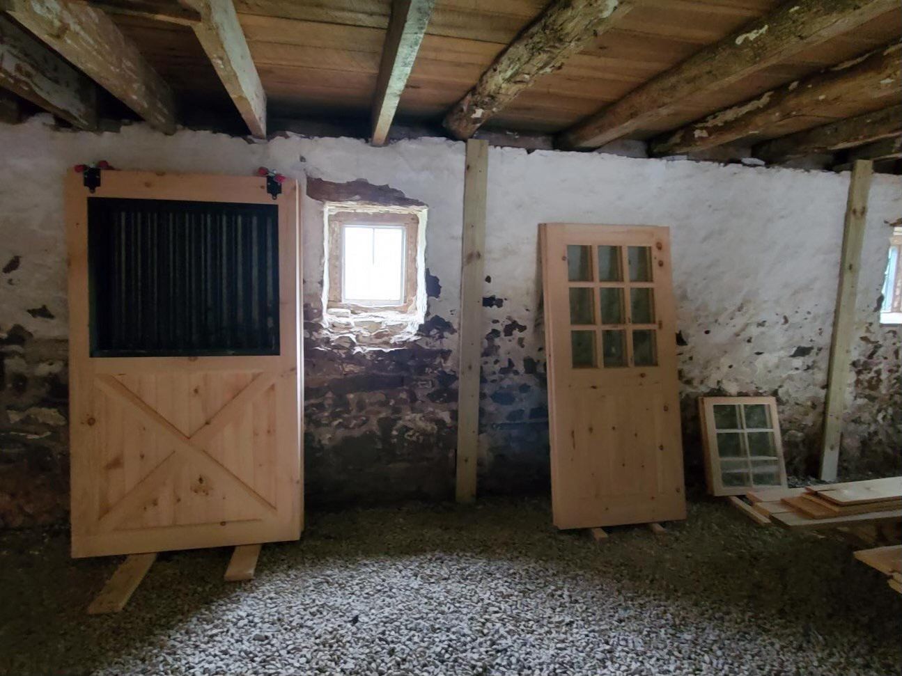 A room with two wooden doors and a window