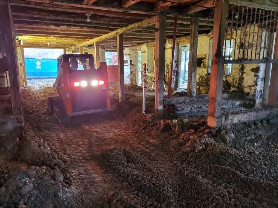 A bulldozer is digging a hole in a building.