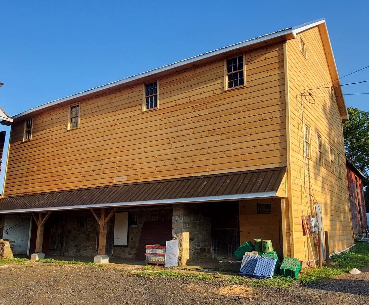 A large wooden barn with a metal roof