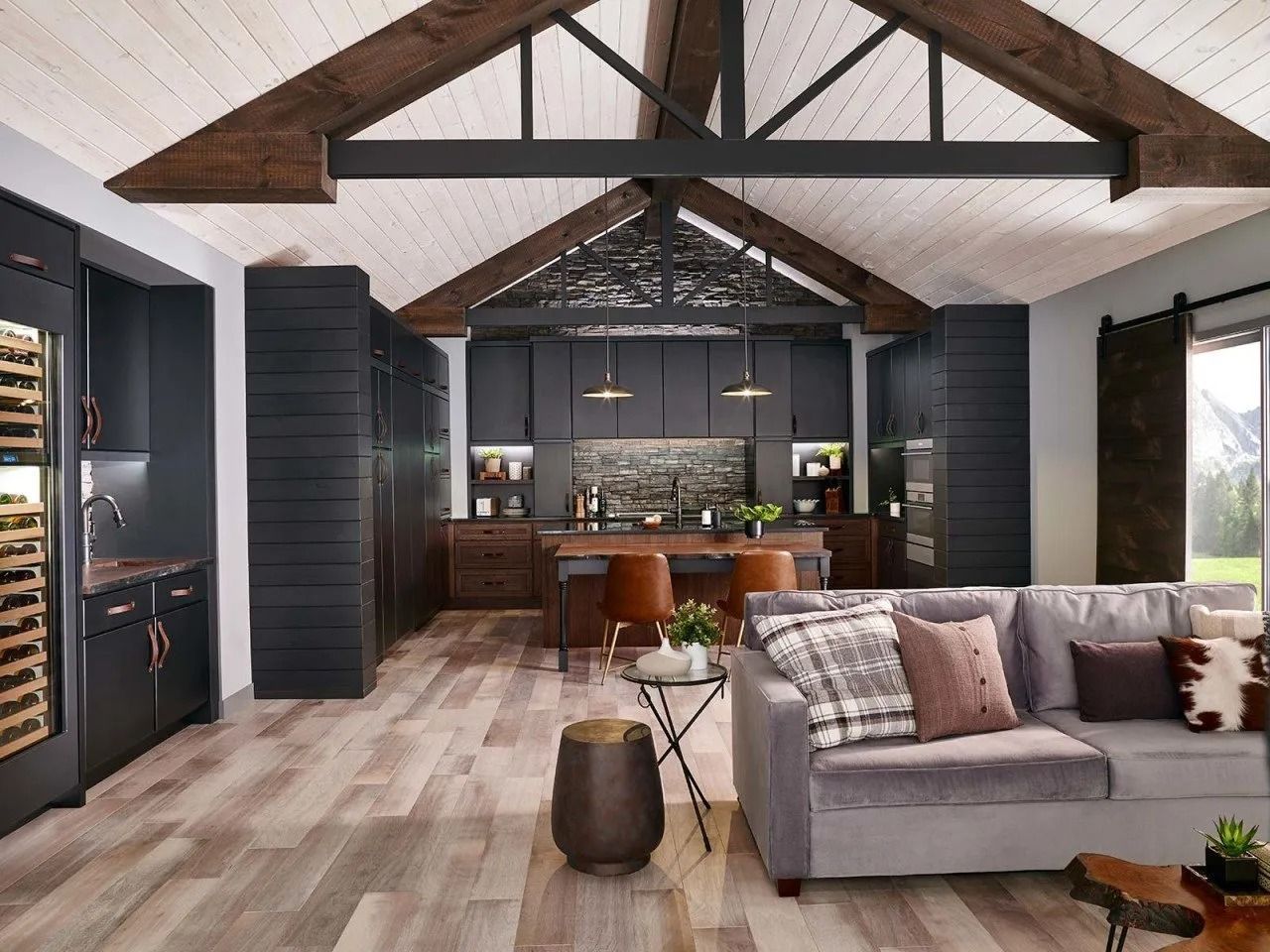 Modern living space with vaulted ceiling, wood beams, and dark cabinetry.