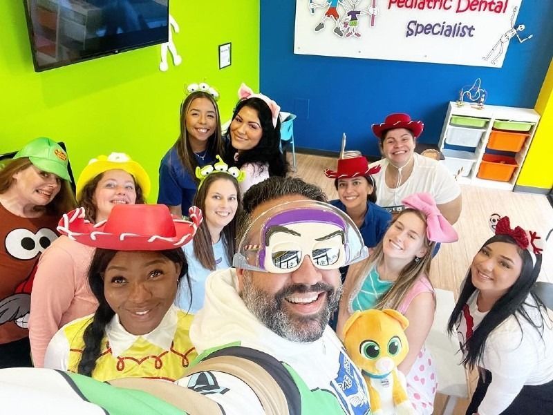A group of people are posing for a picture in a room.