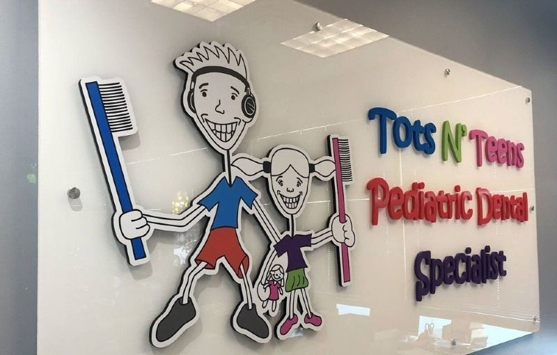 A sign for tots n teens pediatric dental specialists