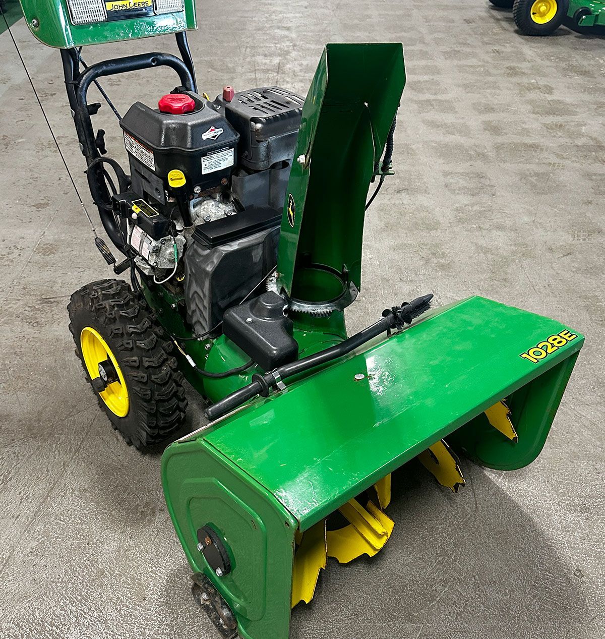 A green 1028E Snowblower