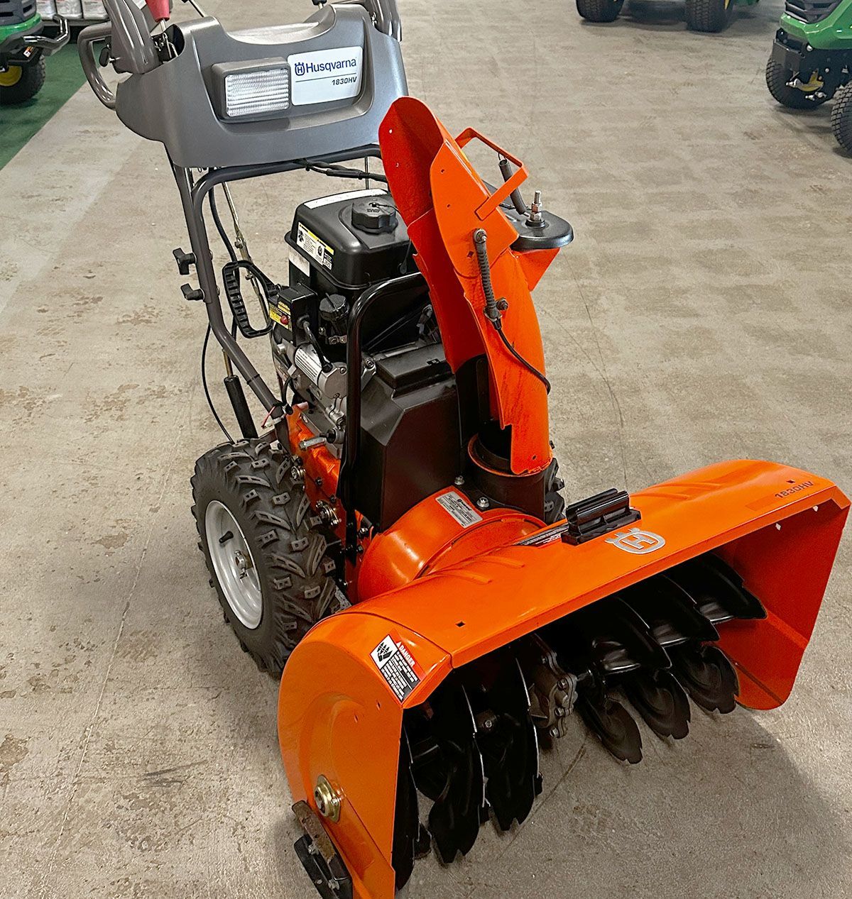 An orange Husqvarna 18530HV snowblower