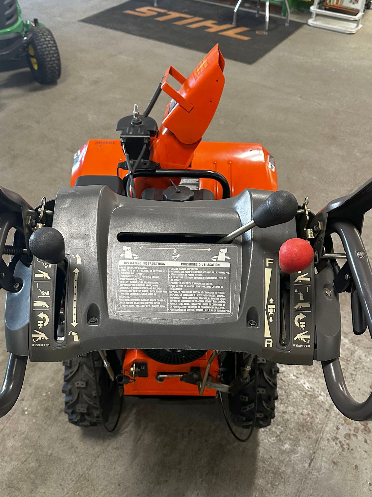 Panel view of an orange Husqvarna 18530HV snowblower