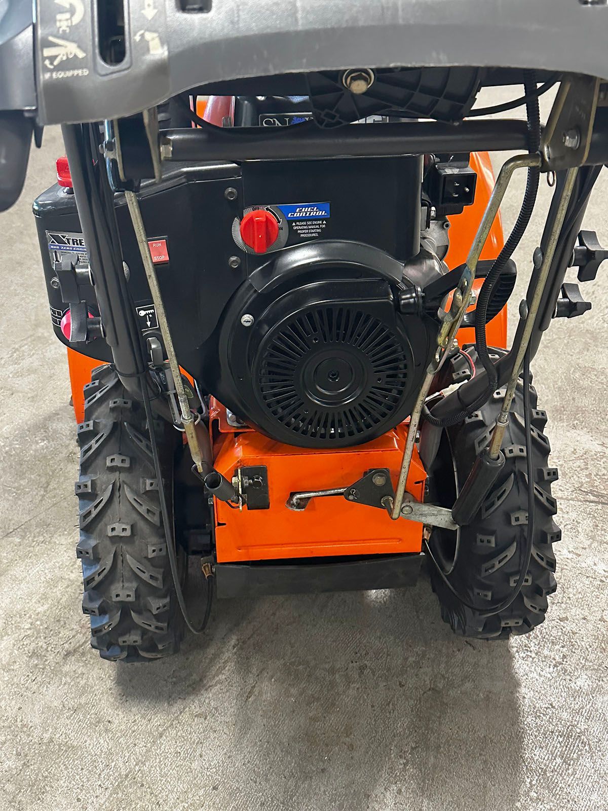 Rear view of an orange Husqvarna 18530HV snowblower
