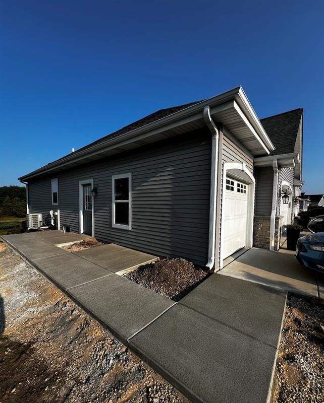 A house with a car parked in front of it