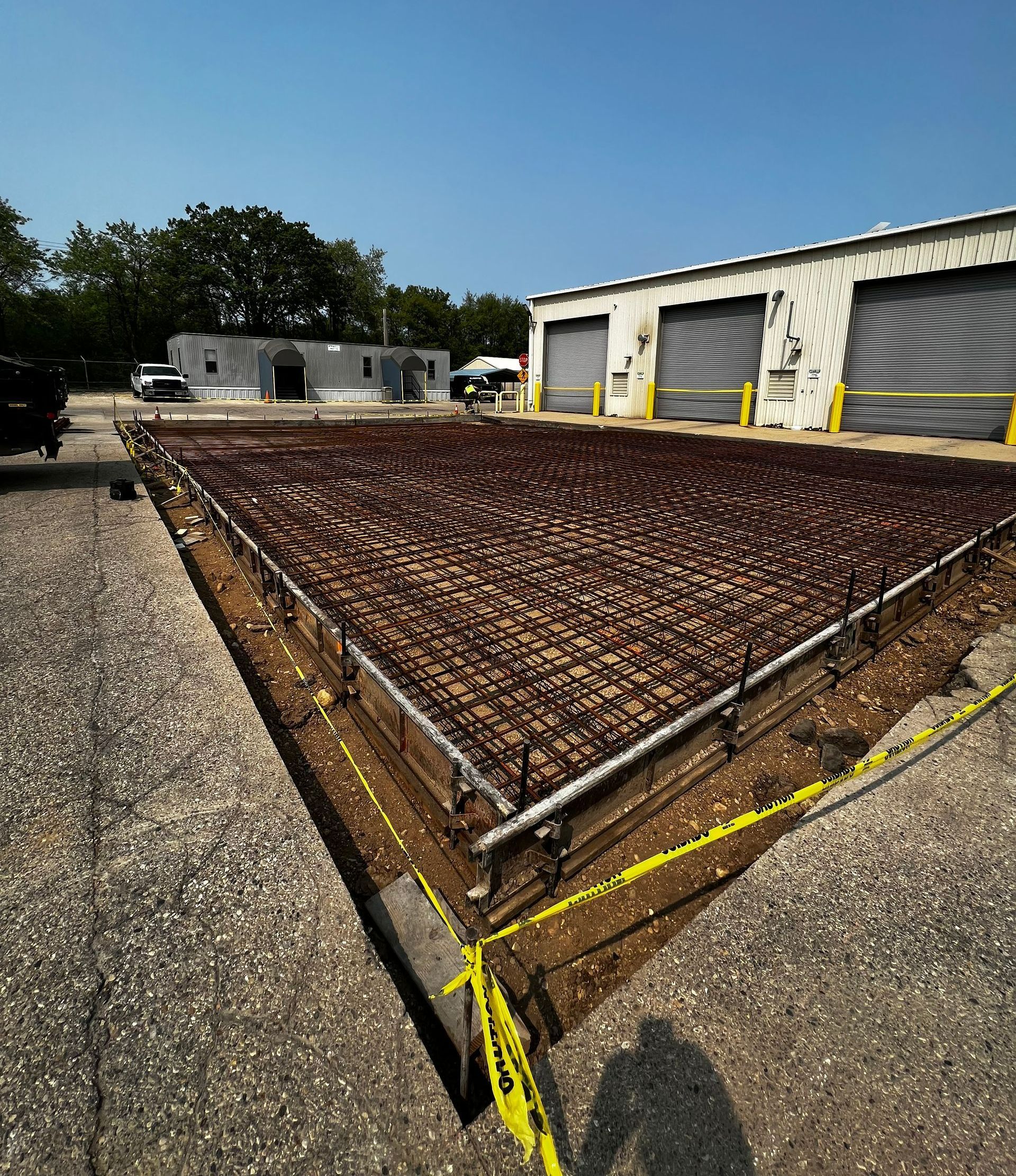 A lot of concrete is being poured in front of a building