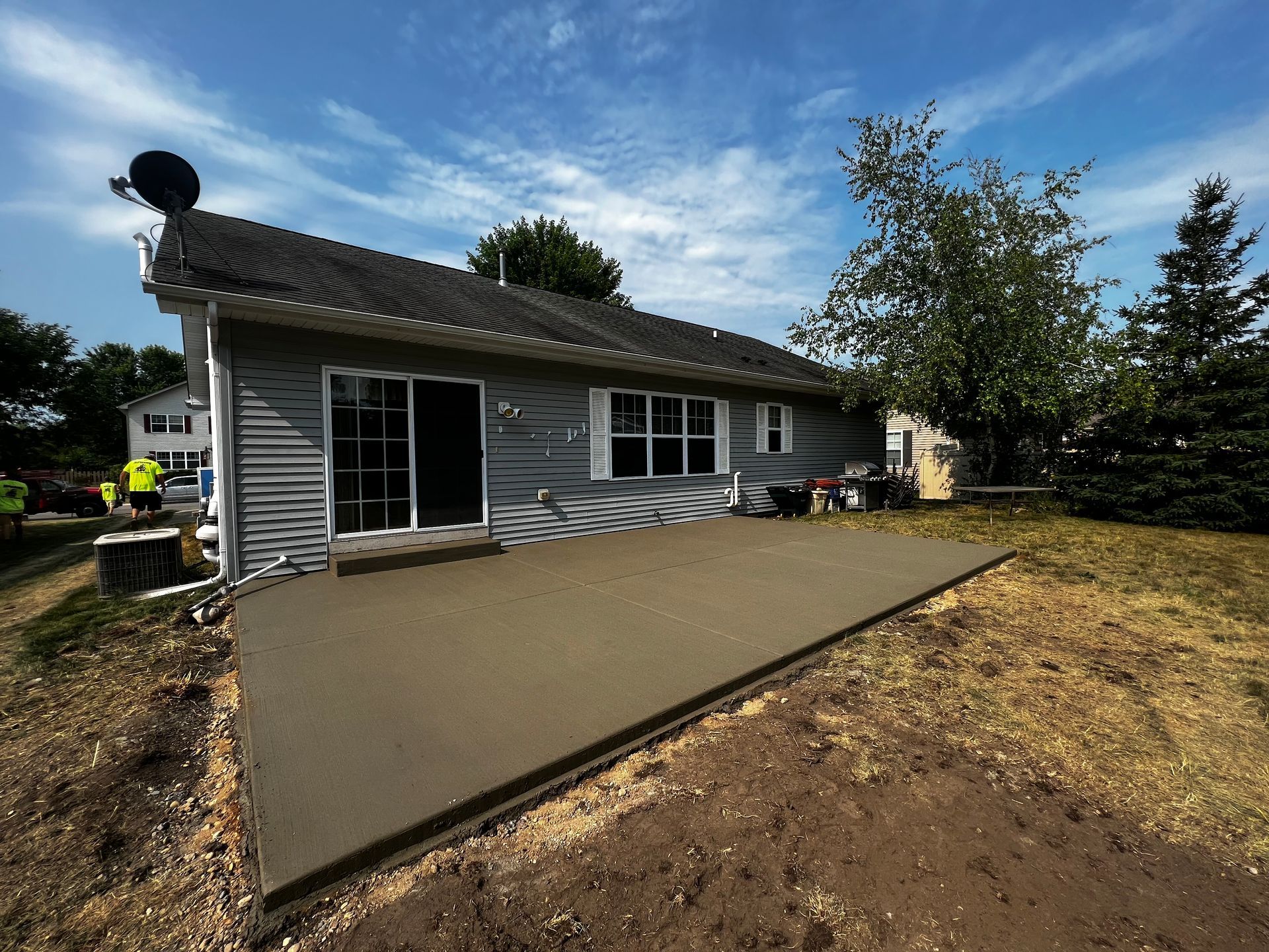 A house with a concrete patio in front of it