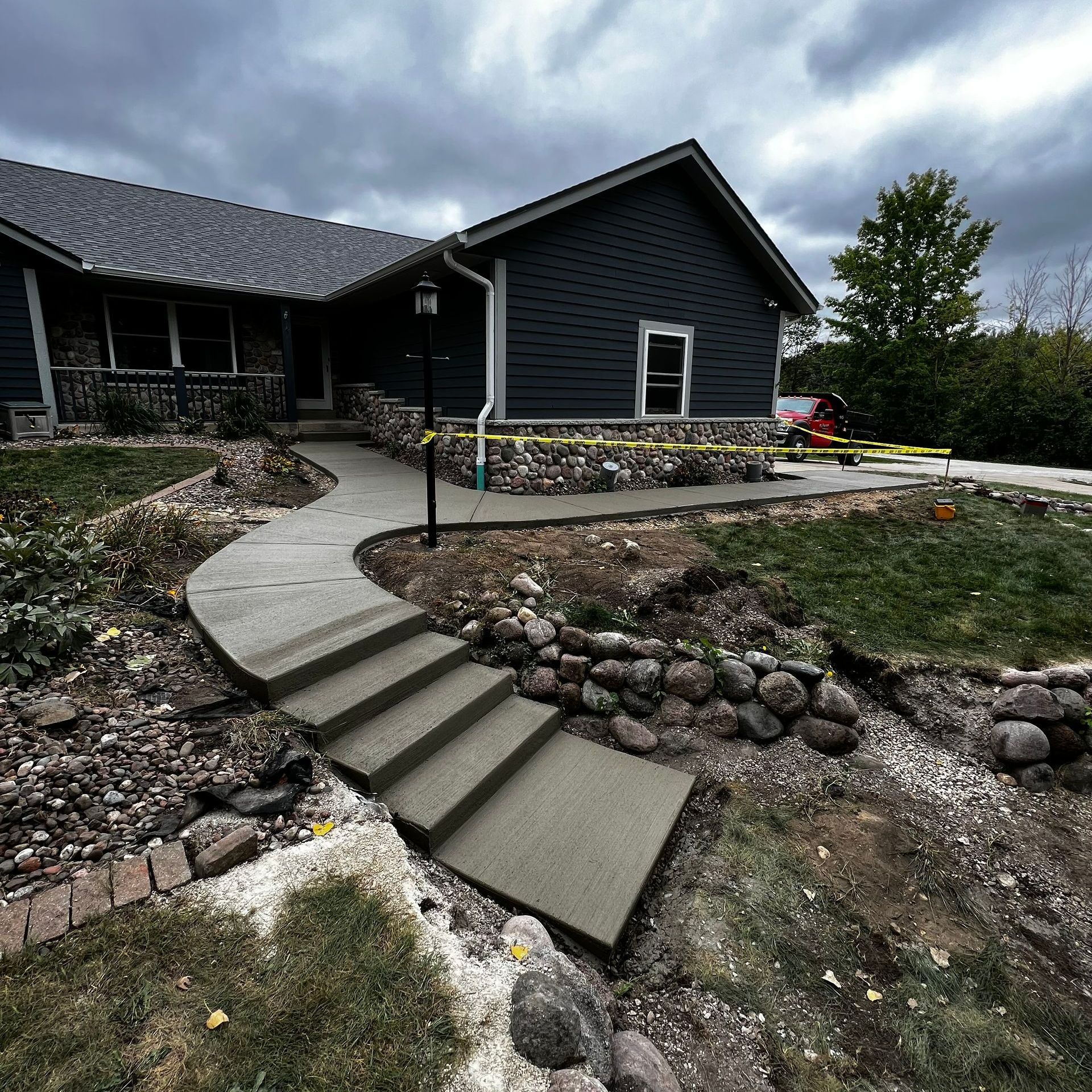 A house with a concrete walkway leading to it