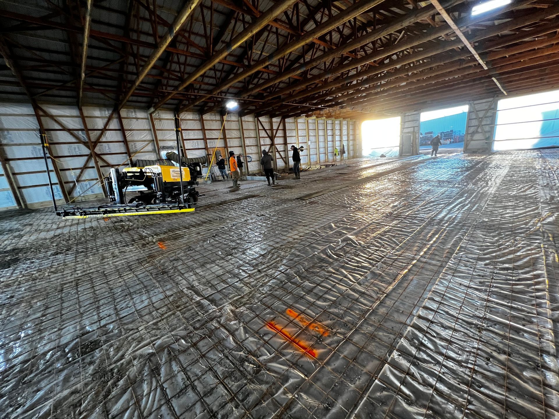A large warehouse with a lot of dirt on the floor.