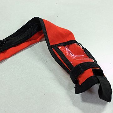 A red and black item with a clear plastic pocket