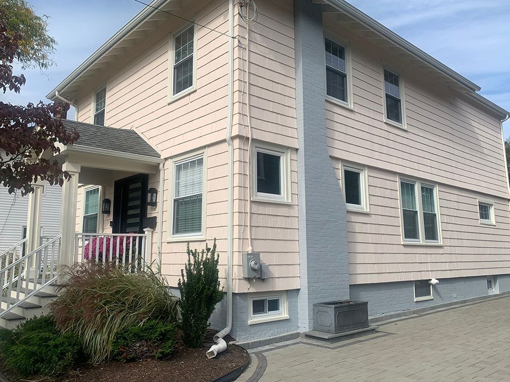 A large house with a lot of windows and a porch