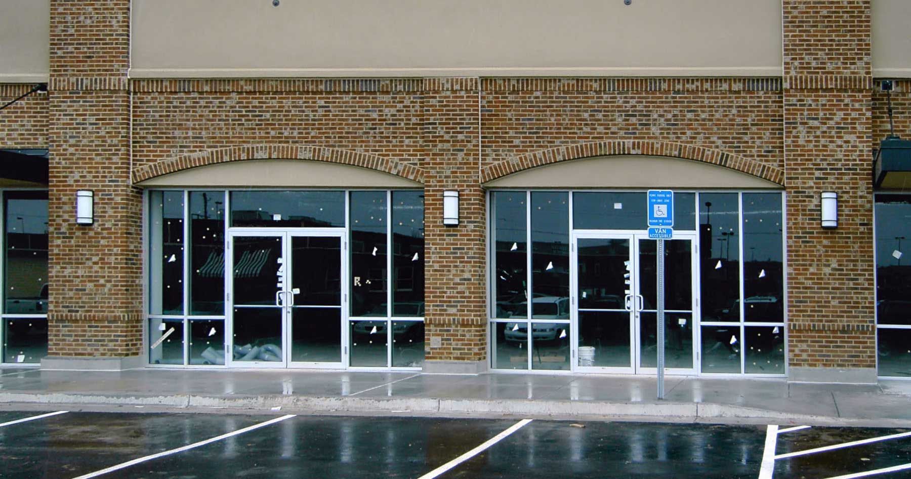 An empty building with a handicapped parking spot in front of it