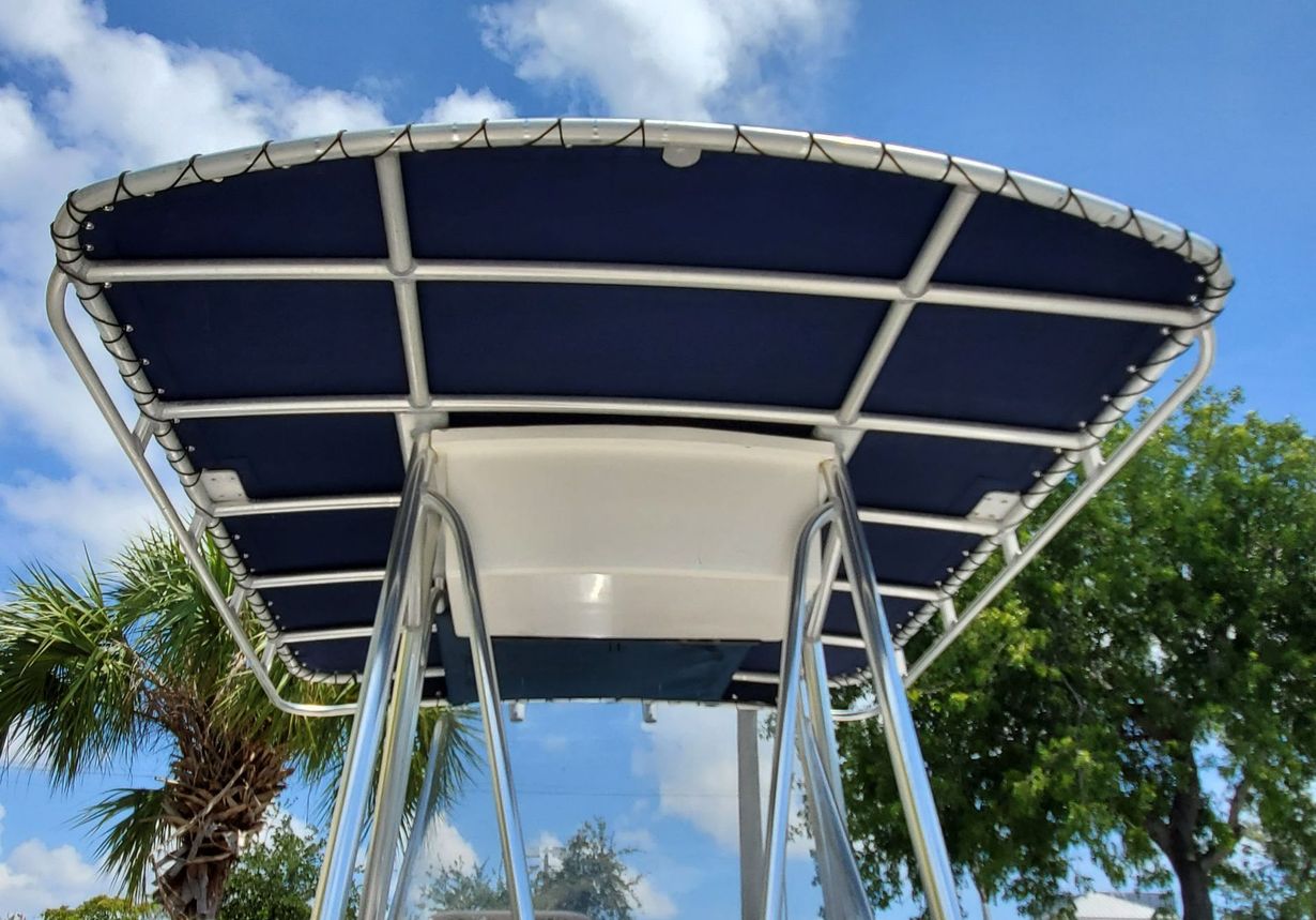 A boat with a blue cover on the top of it