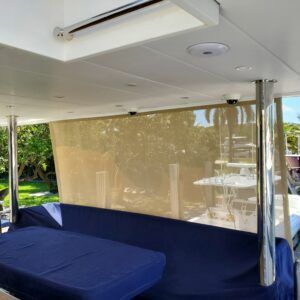 A boat with a blue couch and a large window