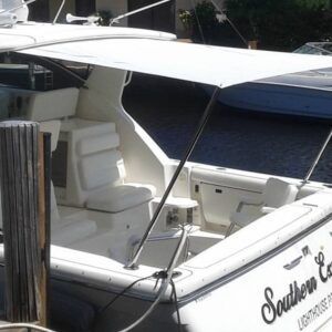 A boat with the name southern is docked at a dock