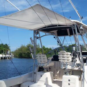 A boat with a canopy on top of it is in the water