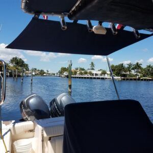A boat with two outboard motors is floating on a body of water
