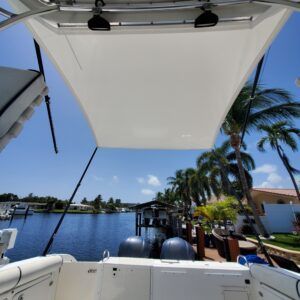 A boat with a canopy on top of it looking out over a body of water