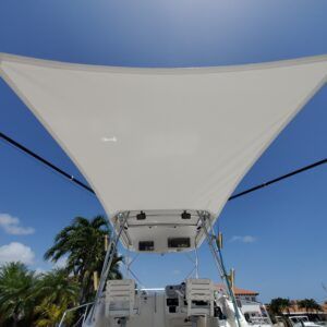 A boat with a white sail on top of it
