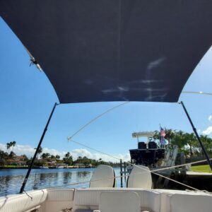 A boat with a canopy on top of it is in the water.