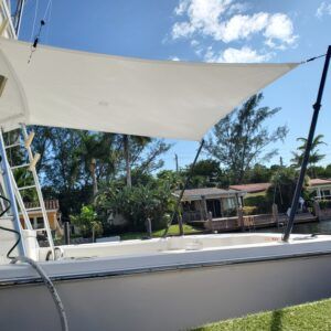 A boat with a large white umbrella on top of it.