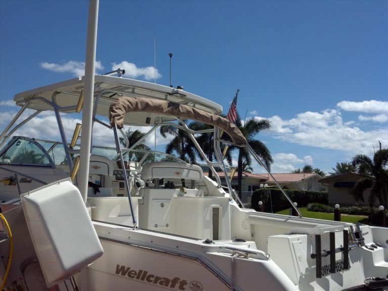 A wellcraft boat is docked in a marina