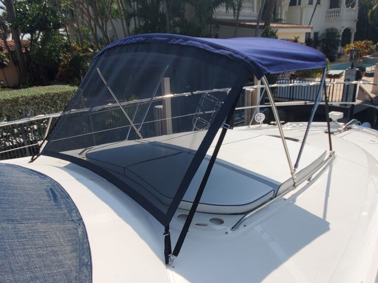 A boat with a blue canopy on top of it