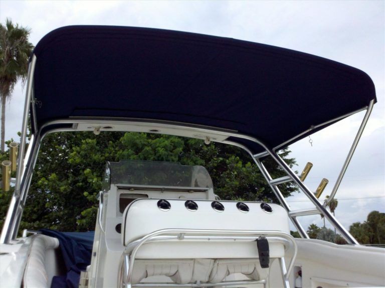 A boat with a blue canopy on top of it