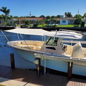 A boat with a canopy is docked at a dock
