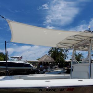 A white boat with a sail on top of it